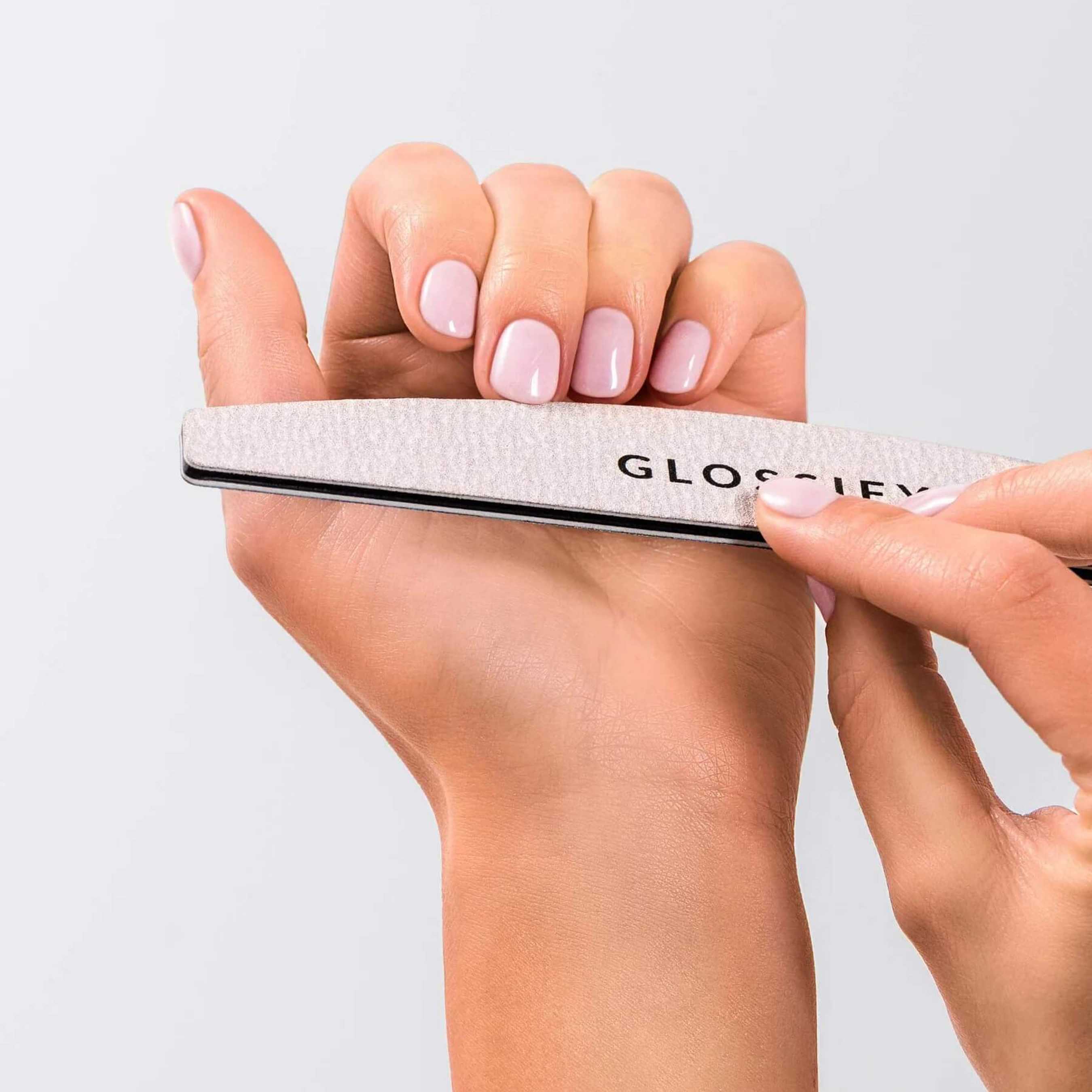 Hand holding a Glossify nail file